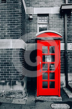 Vertical shot of a red british telephone booth on the street