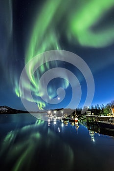 Vertical shot of the reflection of the colorful northern lights in the water