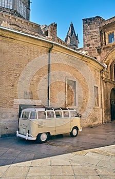 Vertical shot of a retro van near old stone buildings-perfect for wallpapers