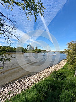 Vertical shot of a river against Canadian Museum for Human Rights in Winnipeg, Manitoba