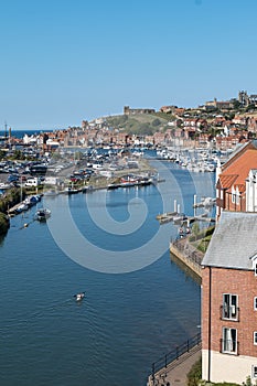 Vertical shot of the River Esk in Whitby with boats and kayaks