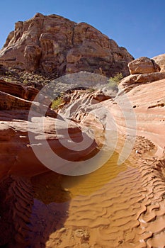 Vertical shot of a river flowing through rocks in Valley of Fire State Park, Nevada