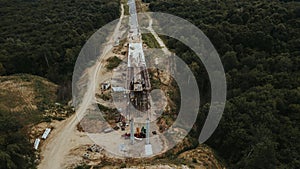 Vertical shot of a  road under construction in Brcko district surrounded by forests