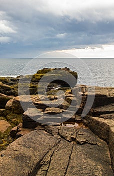 Vertical shot of the rocky coast of the Gouldsboro Bay, Maine