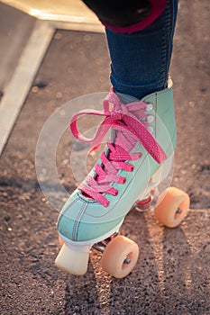 Vertical shot of a rollerskater wearing roller skates with pink laces