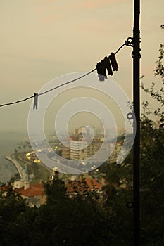 Vertical shot of a rope for hanging clothes with clothesline bans in a suburban area