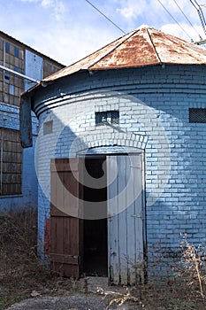 Vertical shot of round brick building at an abandoned factory site