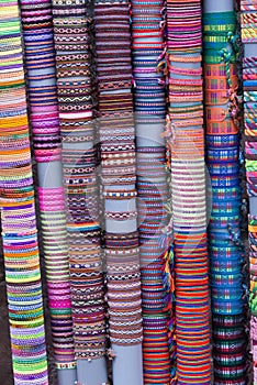 Vertical shot of rows of colorful handmade bracelets