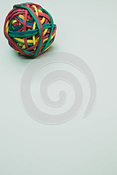 Vertical shot of a rubber ball made out of rubber bands isolated on a white background