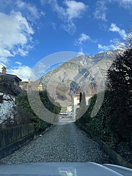 Vertical shot of rural houses and mountains during daytime in Villeneuve, Switzerland