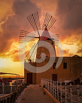 Vertical shot of Saline of Trapani and Pacheco, Italy, during a beautiful orange sunset photo