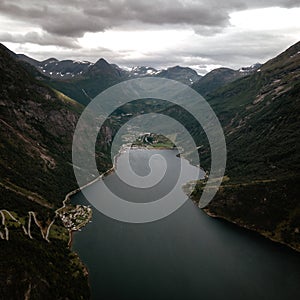 Vertical shot of the scenic hills of Geiranger and river Fjord in Norway