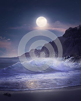 Vertical shot of sea waves on a beach next to the mountains under the bright moonlight