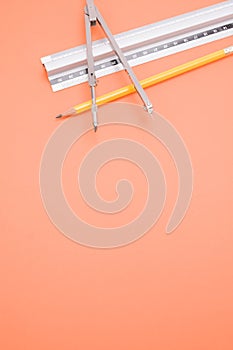 Vertical shot of a set of technical drawing tools on a color background with a copy space