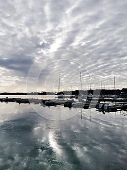 Vertical shot of ships at the harbor under a cloudy sky in Norway