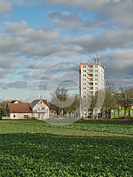 Vertical shot of a single family home and a high rise apartment building