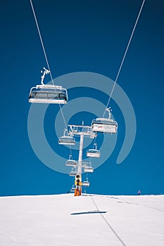 Vertical shot of ski lifts and cable cars in Saalbach ski resort during winter time