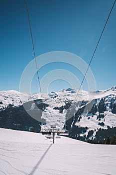 Vertical shot of ski lifts and cable cars in Saalbach ski resort during winter time