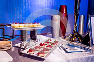 Vertical shot of small delicious cream cakes with berries on a table