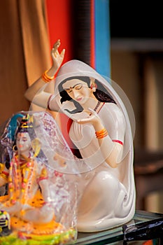 Vertical shot of small religious souvenir of Krishna in the streets of India