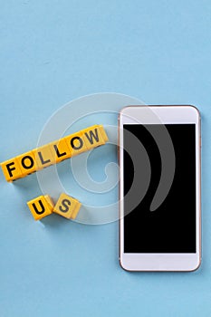 Vertical shot of smartphone and letter cubes.