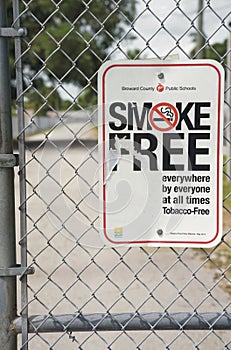 Vertical shot of a smoke-free zone sign in a school area photo