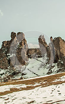 Vertical shot of snowy of strangely shaped Belogradchik Rocks in Bulgaria