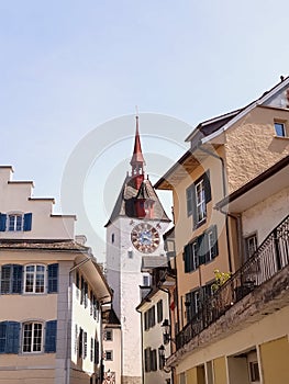 Vertical shot of the Spittelturm gate tower in Switzerland with residential buildings around