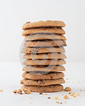 Vertical shot of a stack of chocolate chip cookies isolated on white background