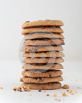 Vertical shot of a stack of chocolate chip cookies isolated on white background