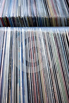 Vertical shot of a stack of old used vinyl records in covers