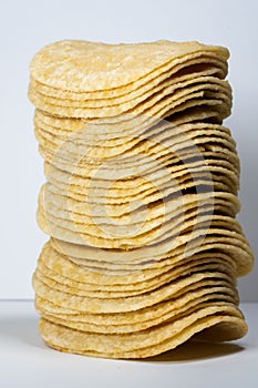 Vertical shot of the stack potatoes chips isolated on gray background