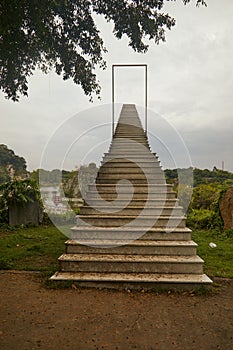 Vertical shot of stairs in a park with a cloudy sky in the background,