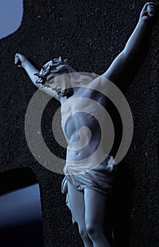 Vertical shot of a statue of Jesus Christ crucified on a black cross