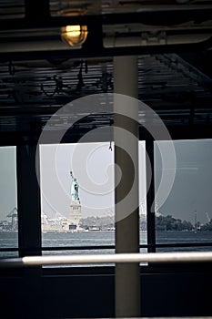 Vertical shot of the Statue of Liberty from Battery Park in New York