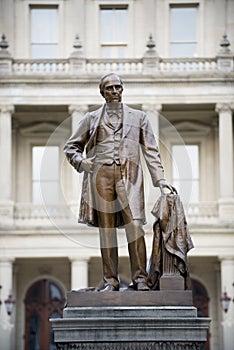 Vertical shot of a statue of a male made by the Michigan Capital building