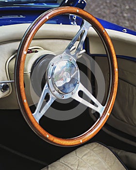 Vertical shot of a steering wheel of an old classic vintage car