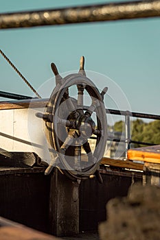 Vertical shot of a steering wheel of an old ship