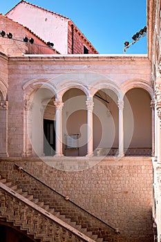 Vertical shot of a stone architecture with a fence