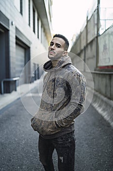 Vertical shot of a stylish young man wearing a hoodie and jeans