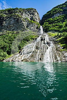 Vertical shot of the Suitor waterfall in Geirangerfjord, Sunnmore, More og Romsdal, Norway photo