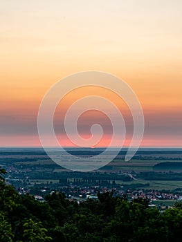 Vertical shot of the sunset sky over the town in summer