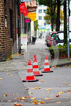 Vertical shot of three traffic cones next to each other on the street