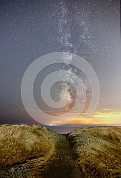 Vertical shot of a trail on the beach in Marbella, Spain under the milky way in the night sky