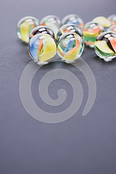 Vertical shot of transparent glass balls on a gray background