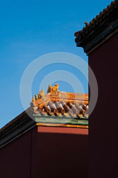 Vertical shot of the turret roofs of Beijing's Forbidden City against a clear blue sky