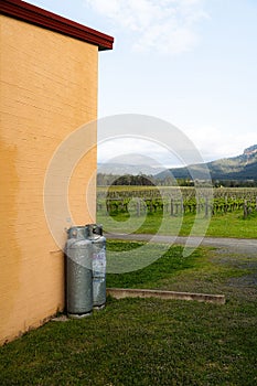 Vertical shot of two gas canisters near the vineyard in Hunter Valley, NSW