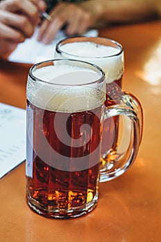 Vertical shot of two mugs of beer