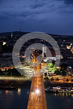 Vertical shot of the UFO Bridge at night in Bratislava, Slovakia