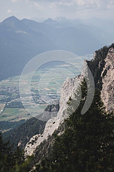 Vertical shot of vast agricultural fields between mountains